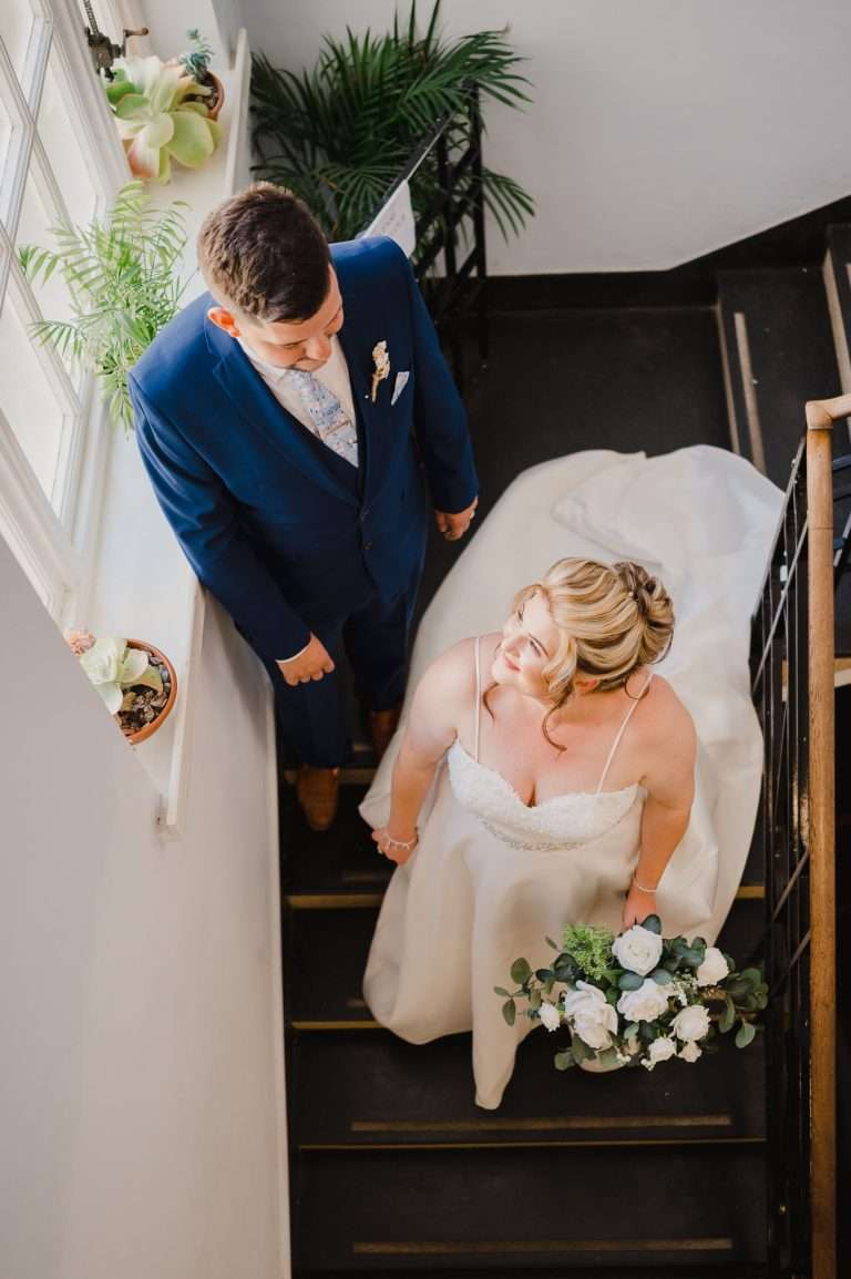 Couple on the stairs at the registry office in St ives for their St Ives Chapel Wedding