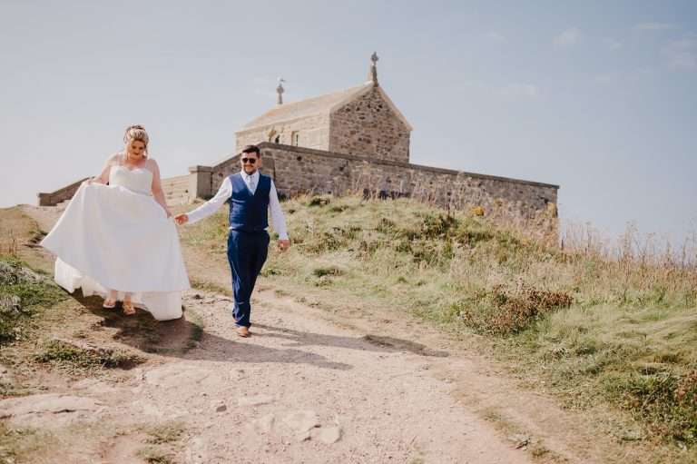 Bride and groom walk away from the St Ives Wedding Chapel