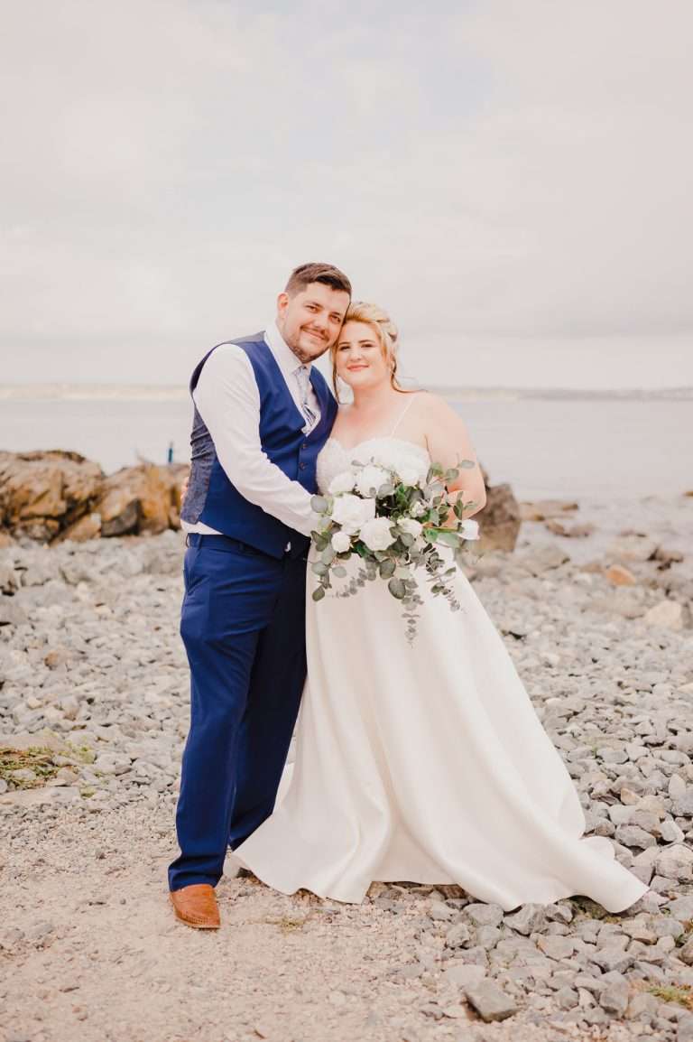Wedding couple pose on the beach for their St Ives Intimate Wedding