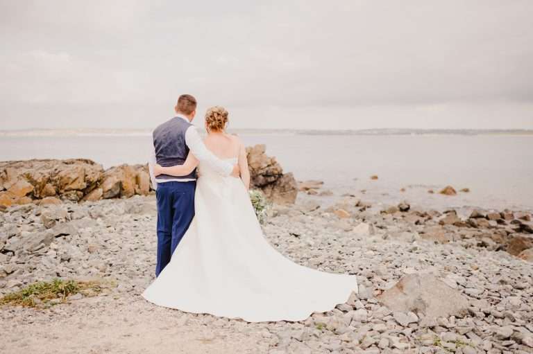 Couple enjoy the view out to sea at St Ives