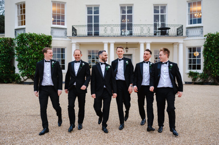 Groomsmen walking away from Rockbeare Manor Wedding Venue - How To Walk In Front Of The Camera At Your Wedding