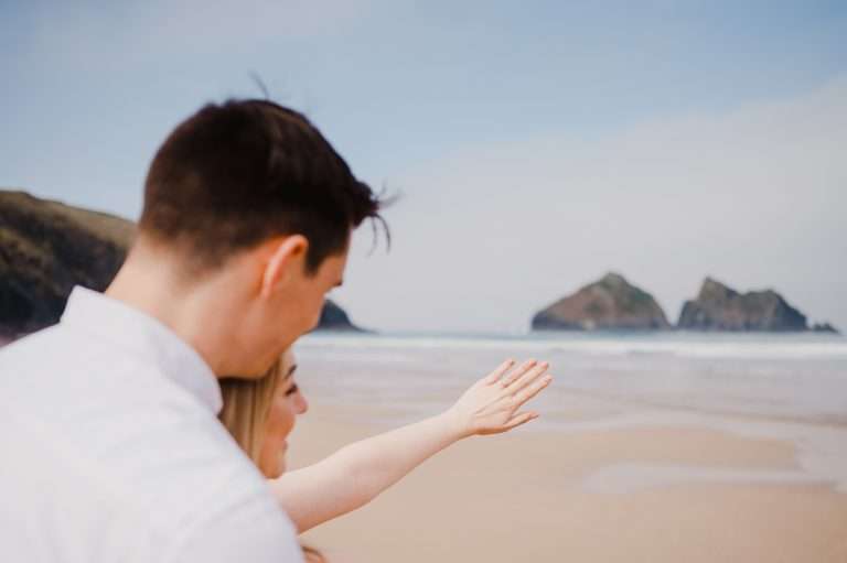 Admiring the engagment ring during their Cornwall Proposal at Holywell Bay