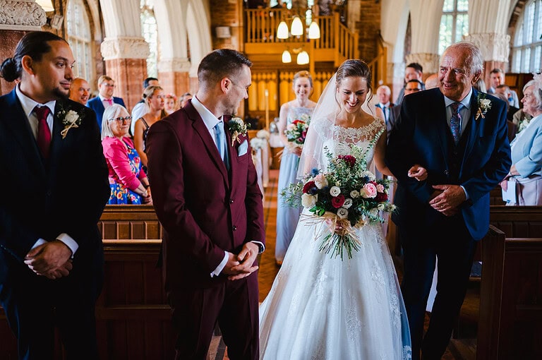Bride and father walks down the aisle - Ultimate wedding photography top tips