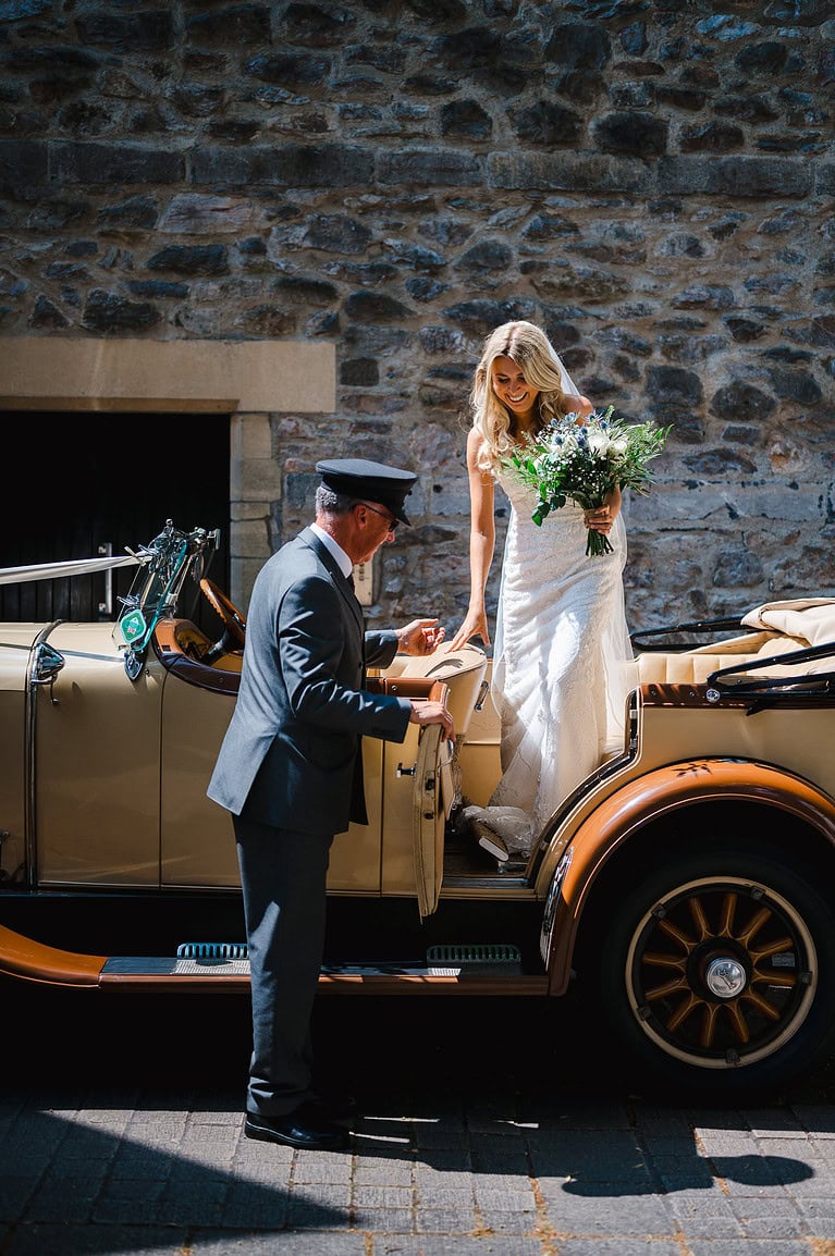 Bride gets out of the wedding car - Ultimate wedding photography top tips