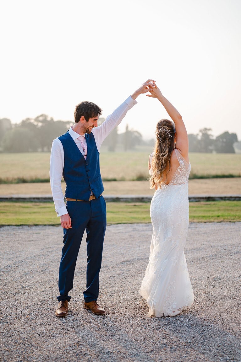 Wedding couple dancing in the sunset light at Rockbeare Manor -20 Amazing Wedding Ideas To Add That Fun Factor