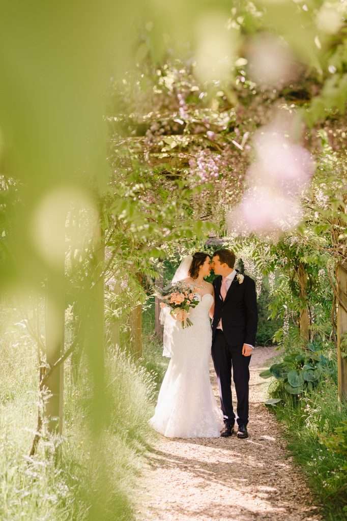 Couple walking down the beautiful garden paths at Minterne House - What Is The Difference Between A Wedding Planner And A Wedding Designer?
