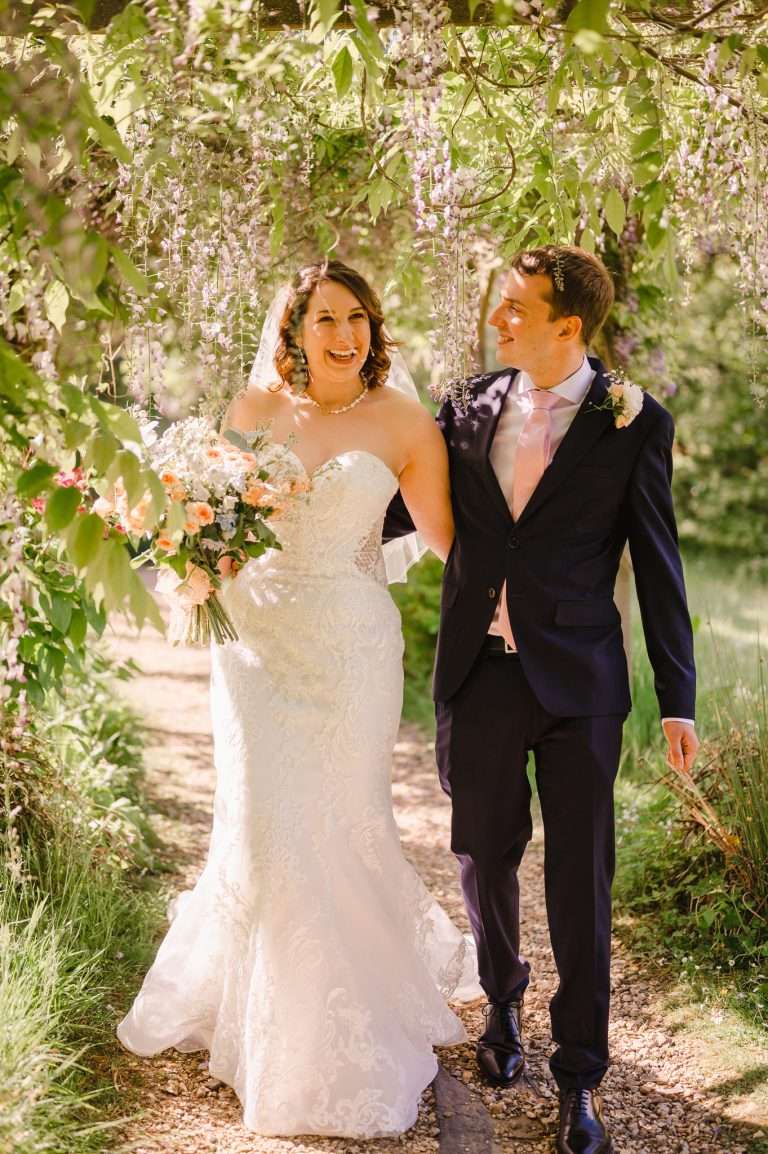 Wedding couple walking through beautiful wedding gardens - The Greatest Guide For Writing A Unique Wedding Speech