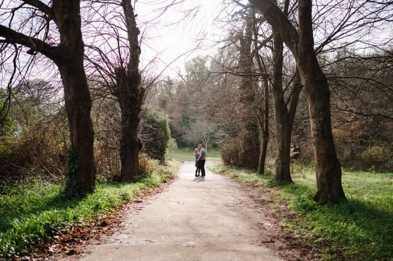 Couple celebrate their engagement at a park in between the trees in Plymouth -Engaged? A Long or A Short Engagement: Which One Is Right For You?