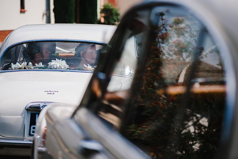 Peering out of the classic wedding cars