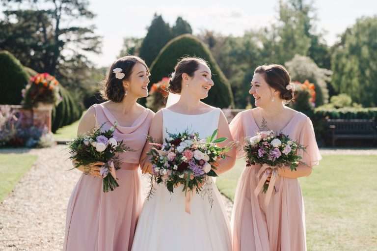 Bridesmaids laughing in the garden - 25 Creative Wedding Planning Tips to Plan Your Dream Wedding