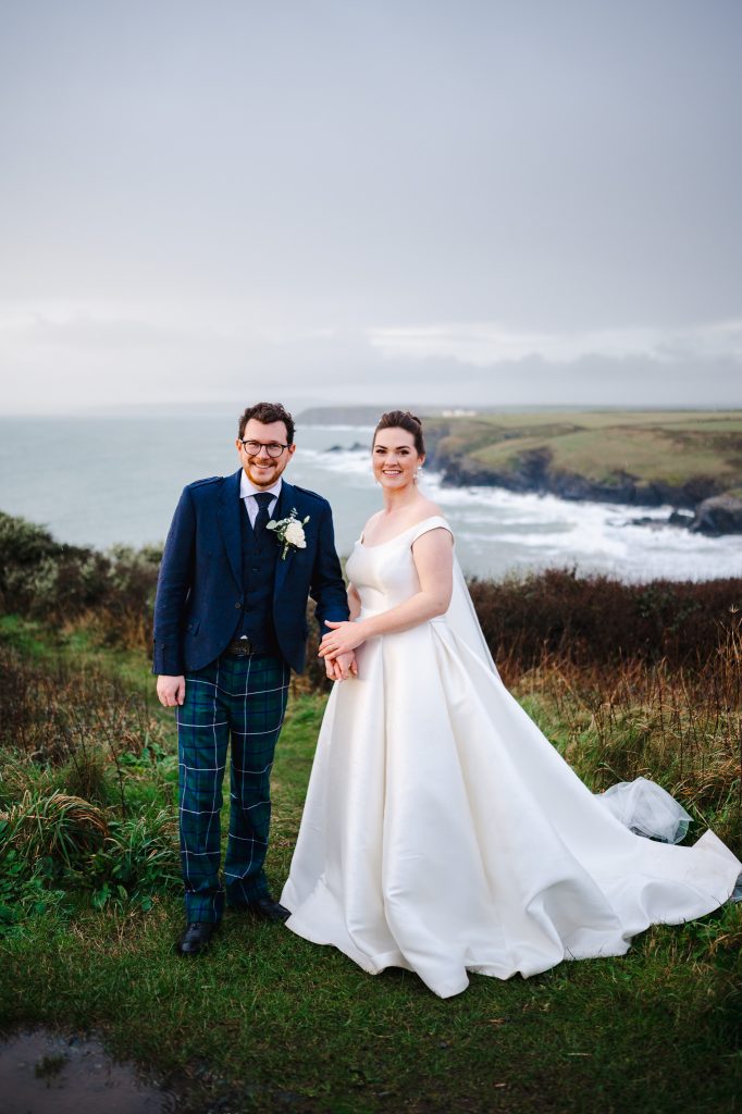 Wedding Couple pose on the cliff tops of Mullion, Cornwall