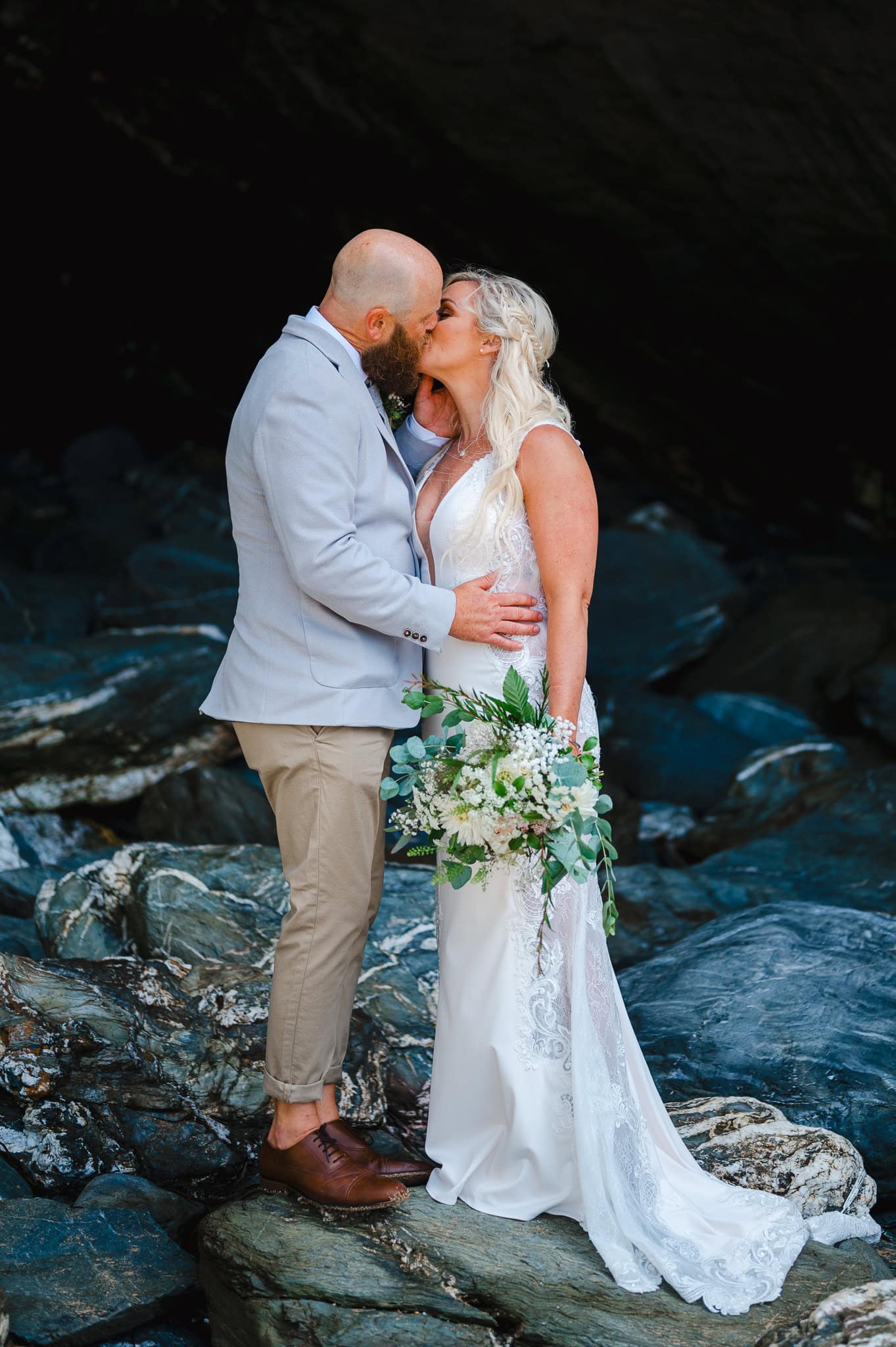 Couple portraits at a rocky cave on Lusty Glaze