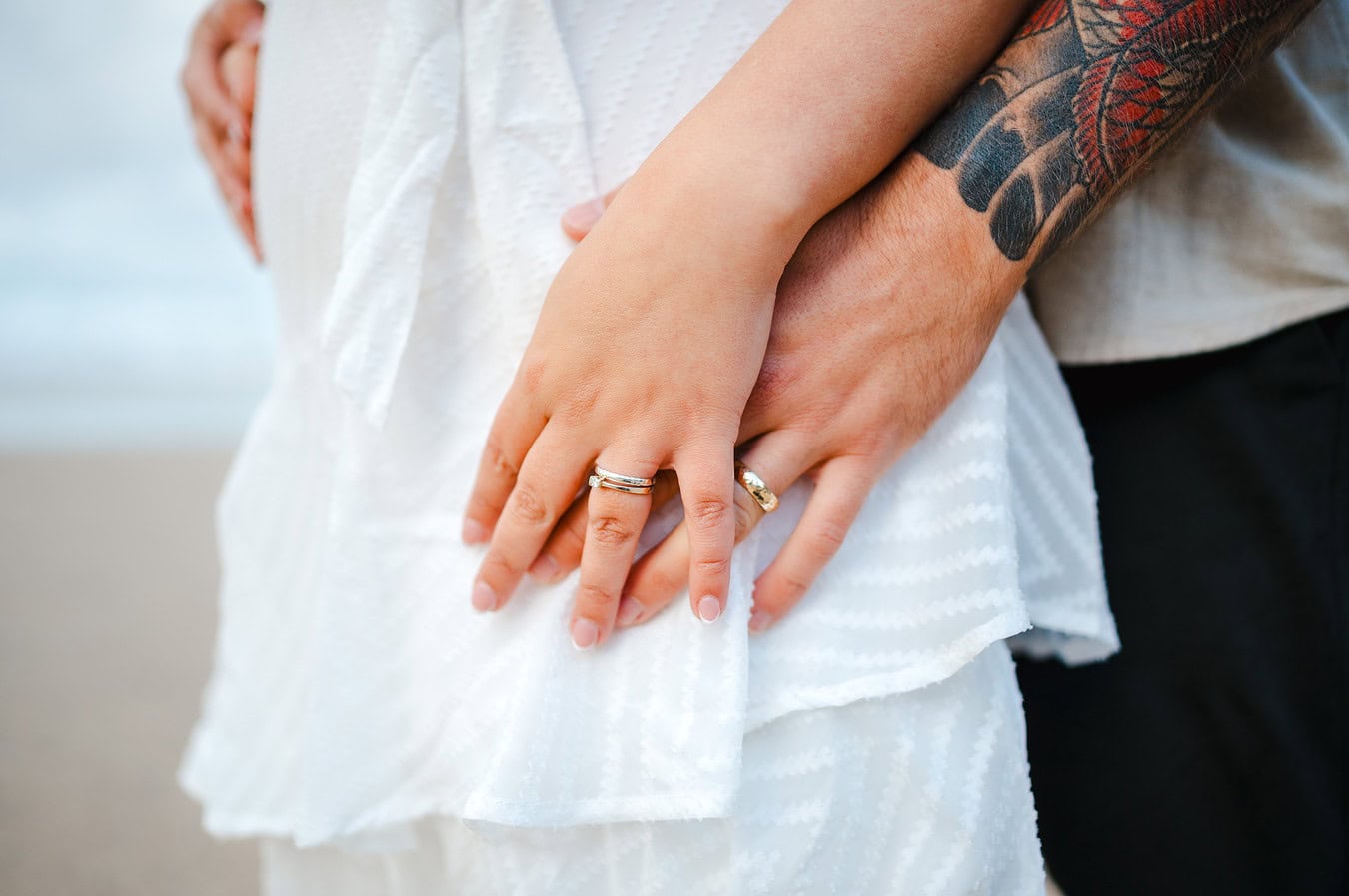 Holding hands and showing off their wedding rings
