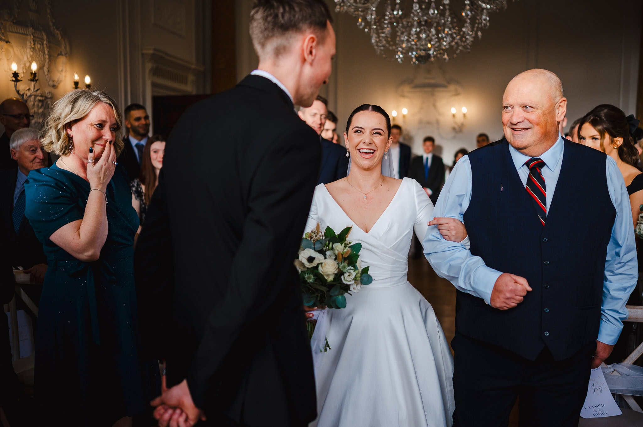 A beautiful moment of father and bride walking down the aisle at Rockbeare manor photographed by Cornwall wedding photographer, Jake Timms Photography