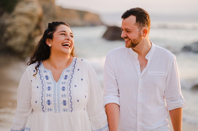 Full of laughter during the happy couples engagement photo shoot celebrations at Godrevy, Cornwall