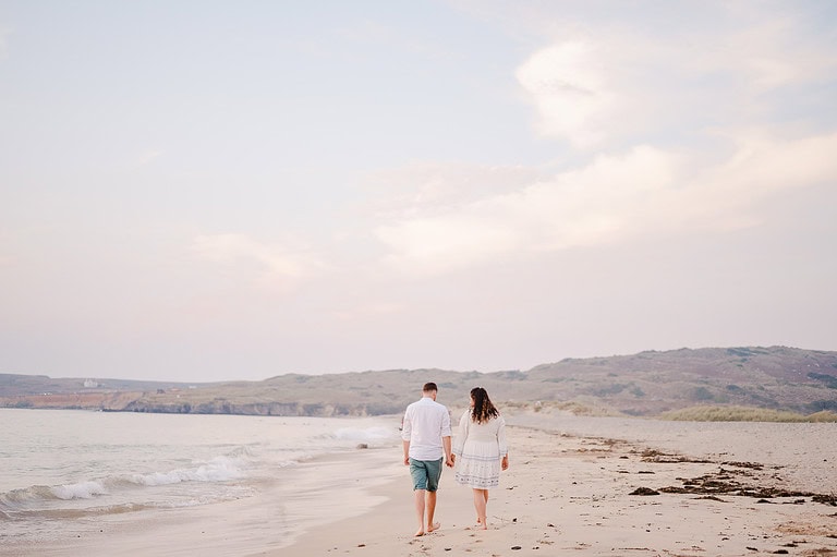 Walking along the vast sandy beach at Godrevy, Cornwall, By Cornwall Engagement Photographer, Jake Timms Photography