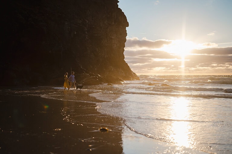 What a view across the whole beach as the golden sun sets out behind the sea by Cornwall Engagement Photographer, Jake Timms Photography