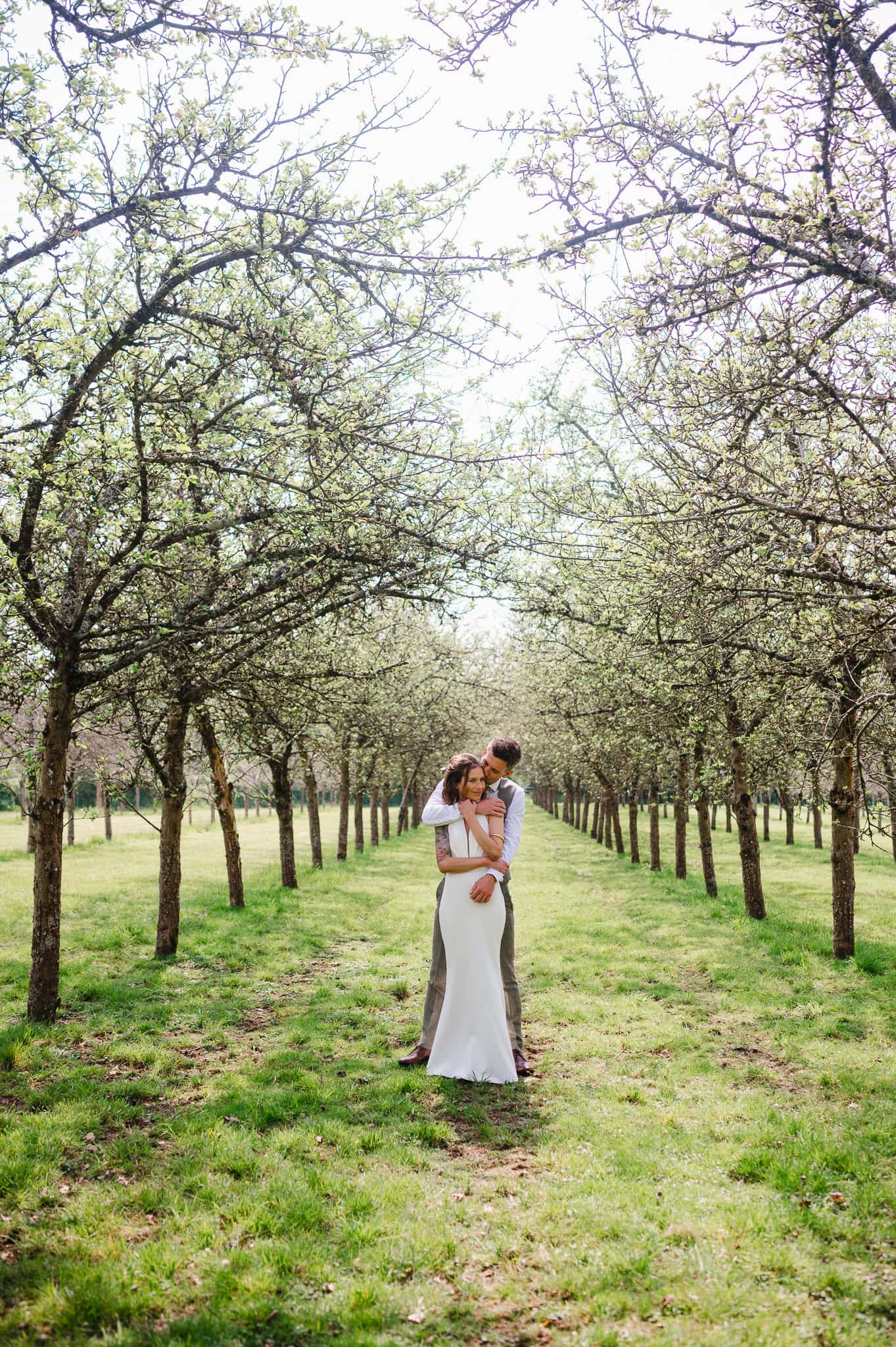 Couple hug and enjoy the beauty of the wedding grounds at Froginwell Vineyard by Devon wedding photographer Jake Timms Photography
