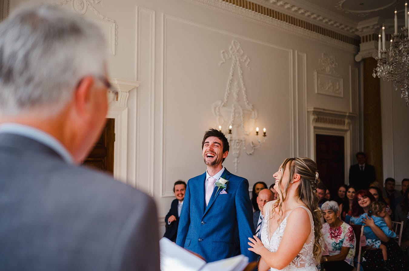 Full of laughter as the happy couple burst out laughing during their wedding ceremony at Rockbeare Manor - Wedding Portfolio