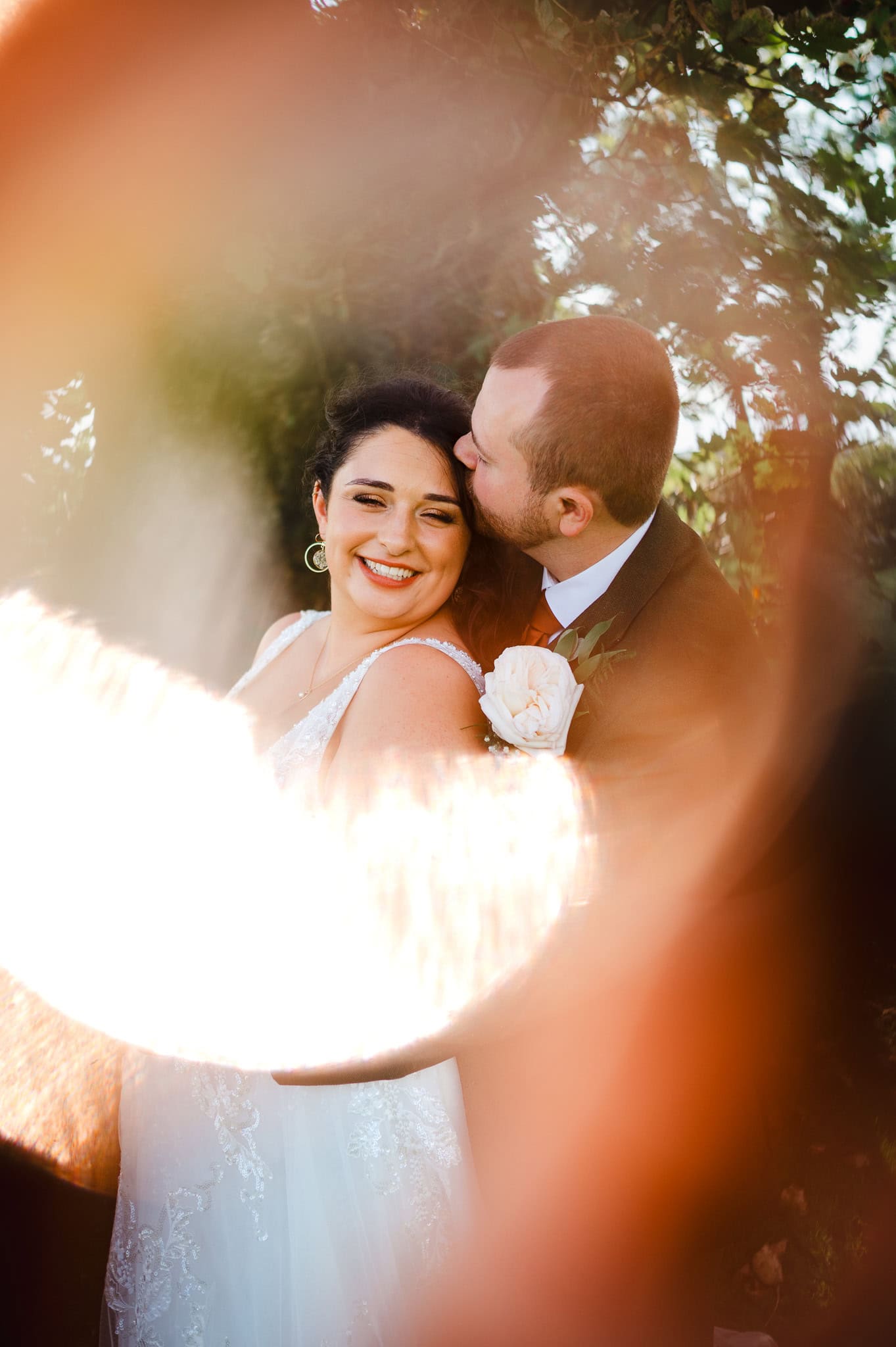 Couple wrap their arms around each other as they pose for an artistic wedding photo by Cheshire Wedding Photographer - Jake Timms Photography