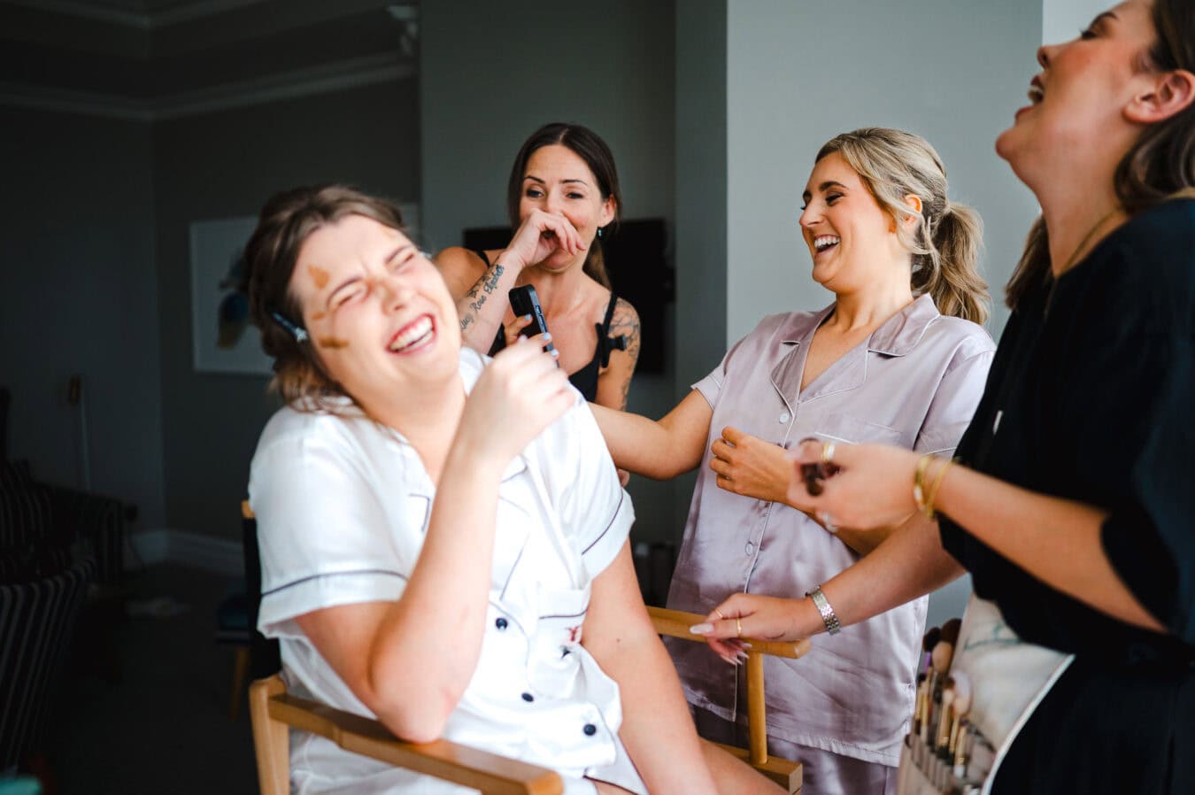 Fun and laughter as the bride gets ready as the bridesmaid shows a hysterical video to the wedding suppliers - Documentary wedding photography, By Jake Timms Photograhy